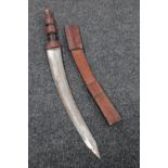 An African sword in leather scabbard