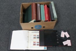 A box of a quantity of stamp albums containing a large collection of assorted stamps,