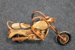 A hand built wooden model of a vintage motorcycle