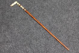 An antique ivory handled walking cane