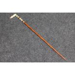 An antique ivory handled walking cane