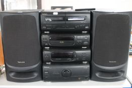 A Technics four piece mini system with speakers and remote