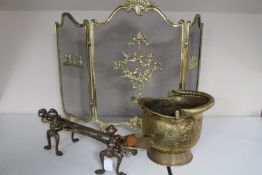 An antique brass embossed coal bucket, set of fire dogs,