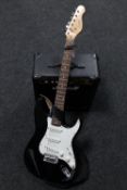 An Encore electric guitar and a Marshall MG Series 15 CD amplifier