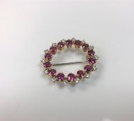 An 18ct gold ruby and diamond brooch, approximately 1.5ct, 7.2g.