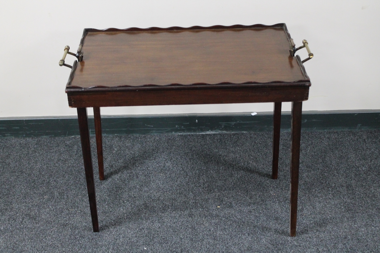 An Edwardian mahogany folding tray table