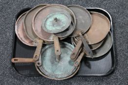 A quantity of antique copper and cast iron pan lids