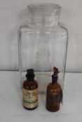 Two antique brown glass chemist's jars and a vintage Easipat lidded jar