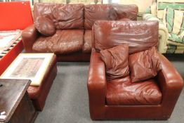 A brown leather two seater settee,