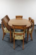 A reproduction mahogany oval extending dining room table with leaf and six chairs