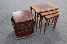 A nest of mahogany tables and a telephone stand