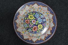 A circular glazed terracotta charger, width 49.