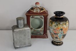 An oriental pottery mantel clock case with character marks to base,