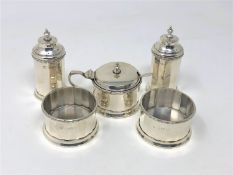 A silver five piece cruet set, comprising two sifters, mustard with spoon and two open salts,