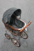 A wooden framed doll's pram