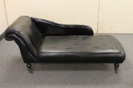A black vinyl chaise longue