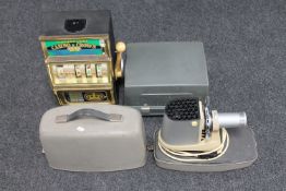 A battery operated one armed bandit and two vintage projectors