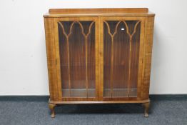 An early 20th century walnut display cabinet