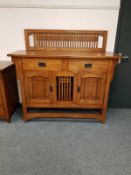 An oak Arts & Crafts style sideboard fitted cupboards and drawers,