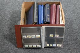 A box of eight folders of Royal Mail presentation packs and first day covers,