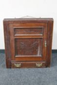 A Victorian carved mahogany corner cabinet