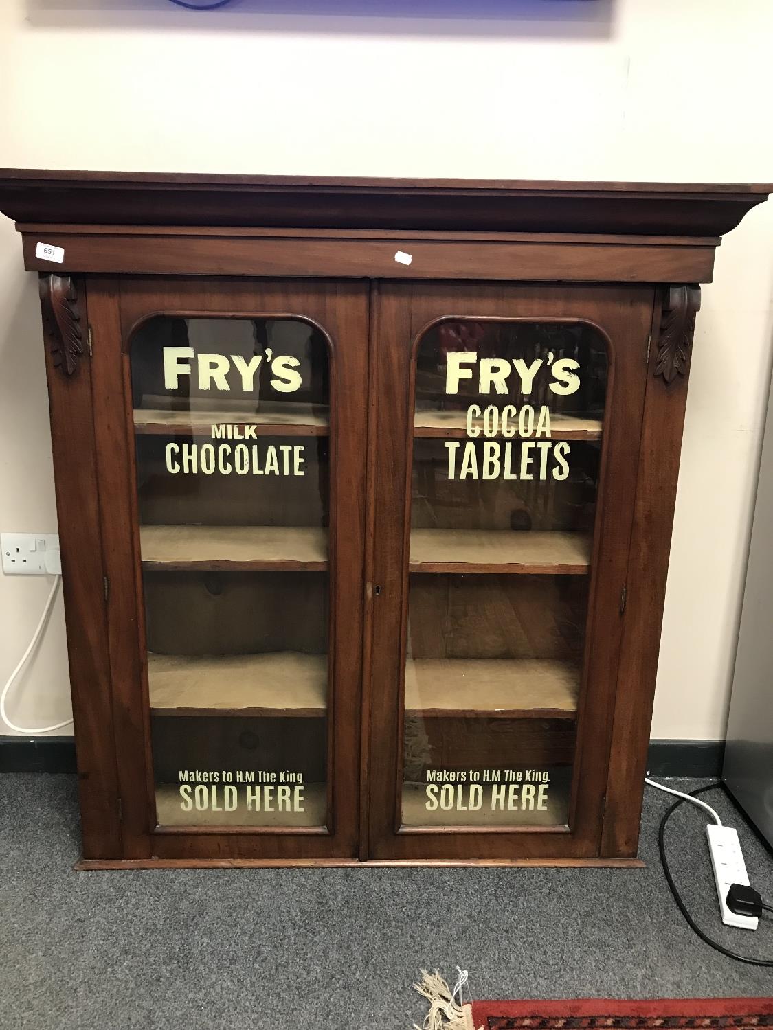 A Victorian mahogany bookcase top with later Fry's Chocolate advertising,