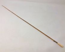 A late Victorian ivory and rhinoceros horn conductor's baton, with yellow metal ferrule,