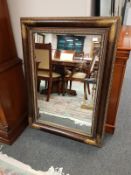 A contemporary bronzed frame overmantel mirror,