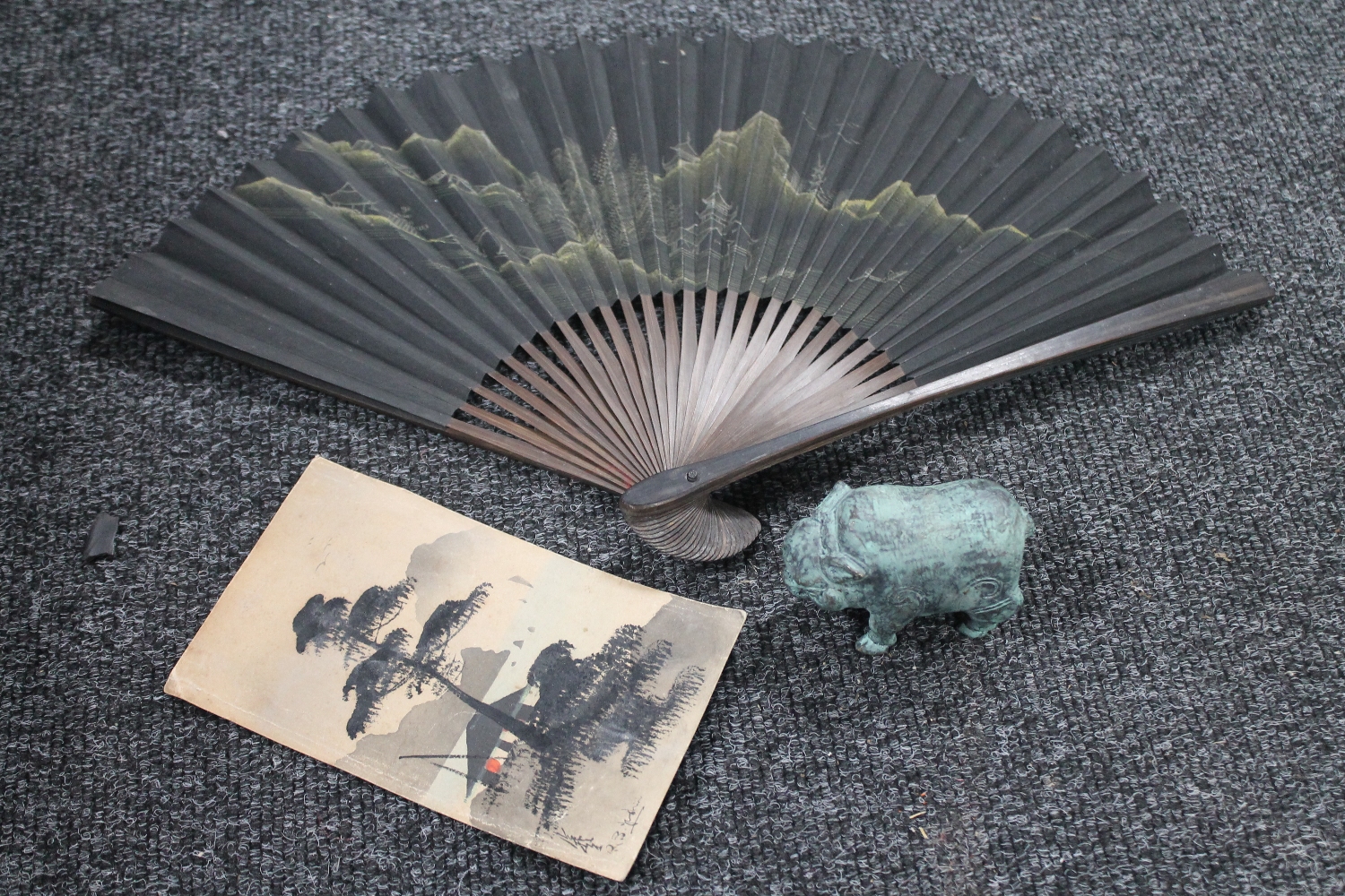 A Japanese watercolour on card together with a hand fan and an Eastern patinated brass figure of a