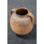 A 20th century terracotta twin handled pot