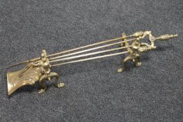 A brass fire companion set with fire dogs