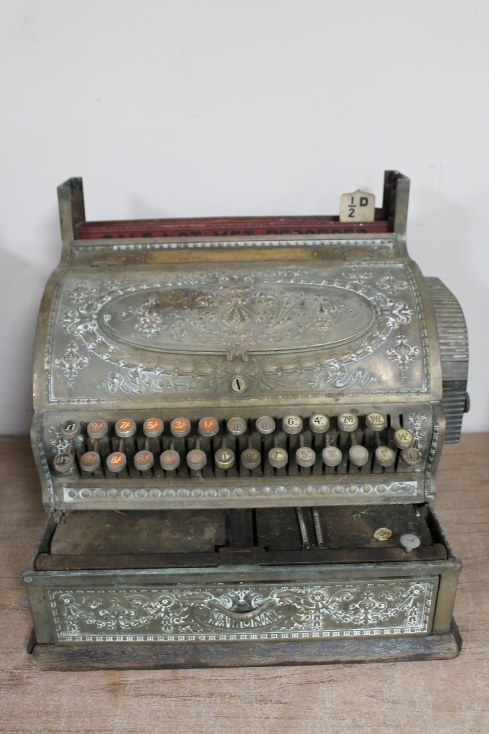 An antique brass National cash register