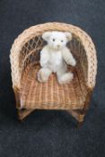 A wicker child's armchair and a Steiff Millennium mohair teddy bear