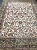 A machine made carpet of Persian design, 340cm by 242cm.