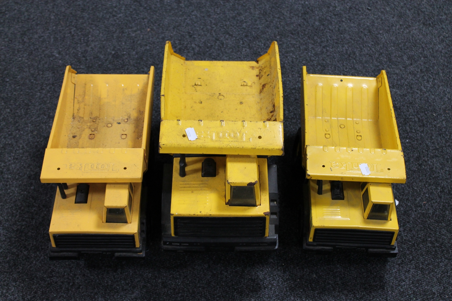 Three Tonka trucks