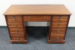 An Edwardian mahogany nine drawer desk