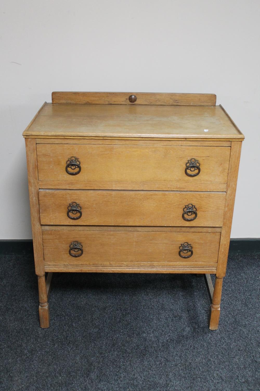 An Edwardian three drawer oak chest