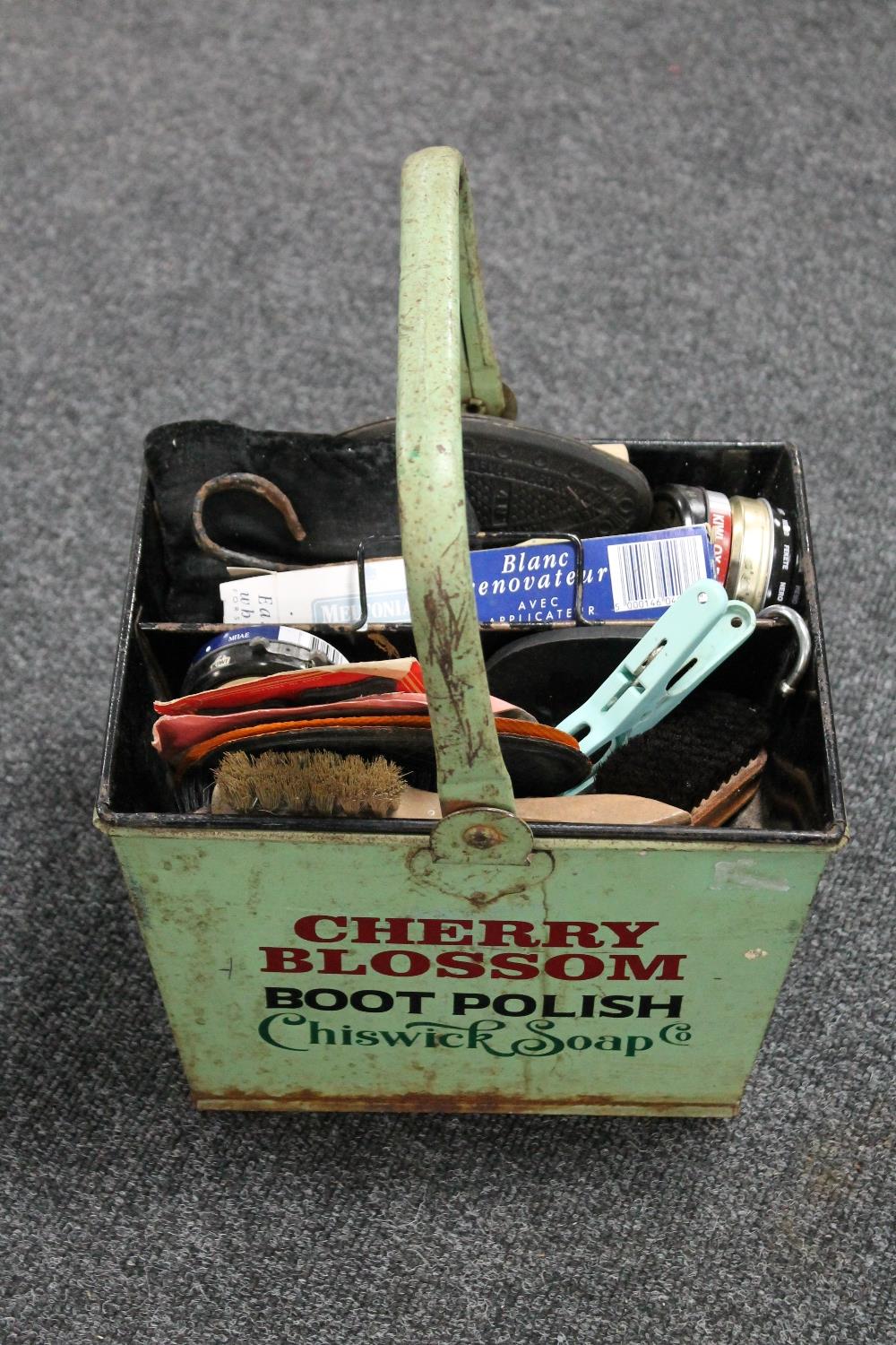 A metal cherry blossom boot polish basket with contents