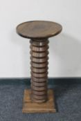 An antique oak torchere