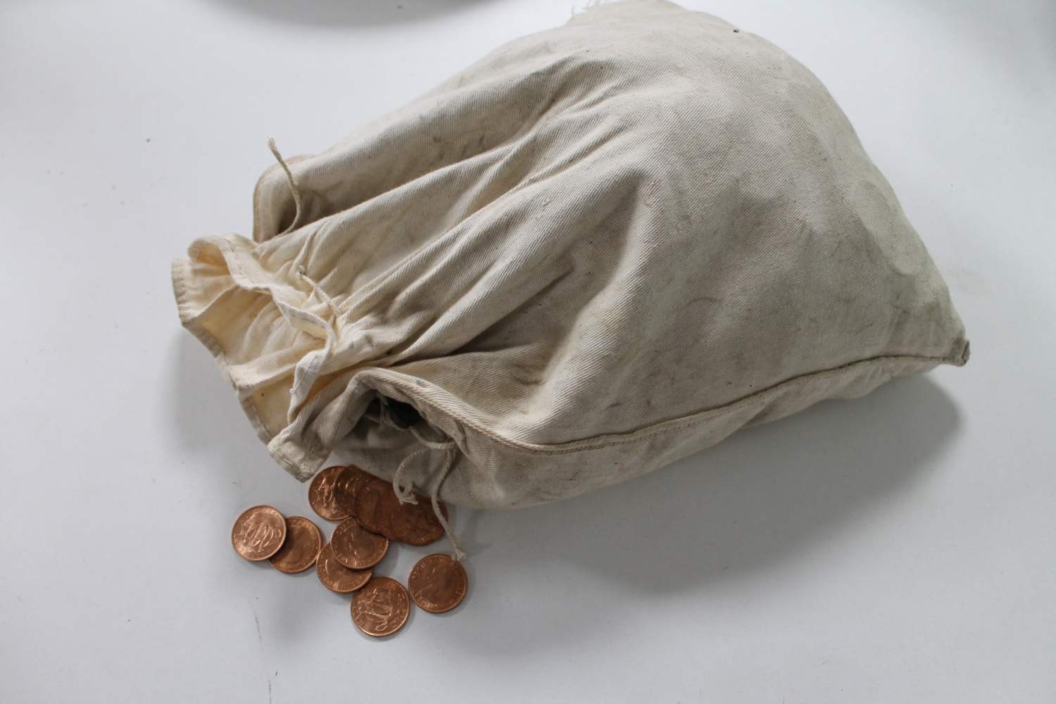 A cloth bag of new un-circulated 1967 half pennies