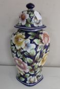 A hand painted pottery lidded vase initial F.V.