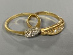 Two 18ct gold three stone and five stone diamond rings (2)