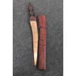 An African sword in leather scabbard