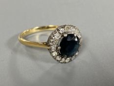 An 18ct gold sapphire and diamond cluster ring