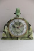 An Art Deco green Bakelite mantel clock fitted with a lamp