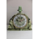 An Art Deco green Bakelite mantel clock fitted with a lamp