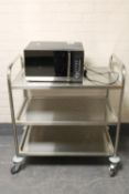A Breville microwave oven and a stainless steel trolley