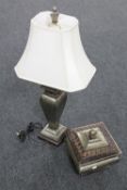 A decorative lidded jar and matching table lamp with shade