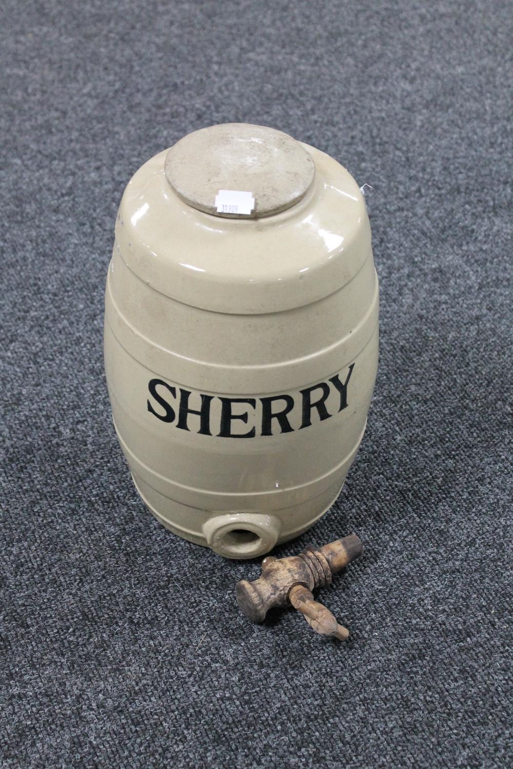 An earthenware sherry barrel with tap