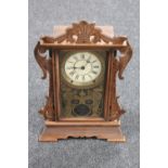 An antique pine cased American mantel clock by the Thomas Clock Company of America